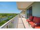 Balcony with serene treetop and waterway views, complete with comfortable seating at 3230 Mangrove Point Dr, Ruskin, FL 33570