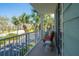 Relaxing balcony with seating, offering views of the neighborhood and lush palm trees at 3230 Mangrove Point Dr, Ruskin, FL 33570