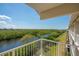 Enjoy serene water views from this condo balcony overlooking lush greenery and a bright blue sky at 3230 Mangrove Point Dr, Ruskin, FL 33570