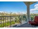 Enjoy neighborhood views from this condo balcony with comfy chair for relaxing at 3230 Mangrove Point Dr, Ruskin, FL 33570