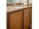 Bathroom vanity featuring granite countertop and wooden cabinets at 3230 Mangrove Point Dr, Ruskin, FL 33570
