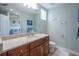 Stylish bathroom with wood cabinets, marble countertops, and decor with a coastal theme at 3230 Mangrove Point Dr, Ruskin, FL 33570