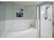 Bathroom featuring a walk-in shower, large tub, and a decorative lighthouse print on the wall at 3230 Mangrove Point Dr, Ruskin, FL 33570