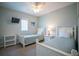 Serene bedroom featuring two beds, beach themed decor, and soft lighting at 3230 Mangrove Point Dr, Ruskin, FL 33570