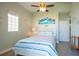 Cozy bedroom with beach themed decor, window, ceiling fan and closet at 3230 Mangrove Point Dr, Ruskin, FL 33570