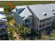 Charming condo complex with manicured landscaping, durable metal roof, and inviting balconies for each unit at 3230 Mangrove Point Dr, Ruskin, FL 33570