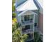 Well-maintained condominium exterior featuring multi-level balconies, lush landscaping, and covered parking at 3230 Mangrove Point Dr, Ruskin, FL 33570