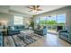 Bright living room with large windows, tile floors, comfortable seating, and stylish decor at 3230 Mangrove Point Dr, Ruskin, FL 33570