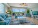 Inviting living room featuring tile flooring, neutral paint, comfortable furniture, and views of the outdoors at 3230 Mangrove Point Dr, Ruskin, FL 33570
