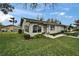 Single-story home showcasing a bright sunroom, a well-kept lawn, and professional landscaping, creating a welcoming exterior at 330 Gloucester Blvd, Sun City Center, FL 33573