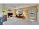 Cozy living room featuring neutral walls, carpeted floors, a ceiling fan, and natural light streaming through the window at 330 Gloucester Blvd, Sun City Center, FL 33573