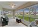 Well-lit sun room provides views of the green outdoors through bright windows at 330 Gloucester Blvd, Sun City Center, FL 33573