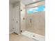 Shower with glass door and window to let in natural light at 3461 Timber Crossing Ave, Brandon, FL 33511