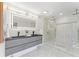 Modern bathroom with a double vanity, a lighted mirror, and a glass-enclosed shower at 4520 Pine Hollow Dr, Tampa, FL 33624