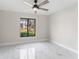 Well-lit room showcasing smooth white walls and a large window that overlooks the neighborhood at 4520 Pine Hollow Dr, Tampa, FL 33624