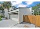 View of home's exterior featuring a garage and neatly kept front yard with lush landscaping at 4520 Pine Hollow Dr, Tampa, FL 33624