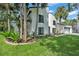 Modern home exterior with well-maintained lawn, lush landscaping, and plenty of curb appeal at 4520 Pine Hollow Dr, Tampa, FL 33624