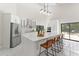 Modern, white kitchen featuring a large center island and stainless steel appliances at 4520 Pine Hollow Dr, Tampa, FL 33624