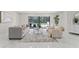 Open living space with large sliding doors to the pool area and marble flooring at 4520 Pine Hollow Dr, Tampa, FL 33624