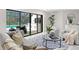 Comfortable living room featuring neutral tones, backyard views, and marble floors at 4520 Pine Hollow Dr, Tampa, FL 33624