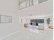 Bright living room with white marble floors and large windows overlooking the pool at 4520 Pine Hollow Dr, Tampa, FL 33624
