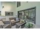 Covered patio with comfortable seating, an outdoor kitchen, and a view of the pool area at 4520 Pine Hollow Dr, Tampa, FL 33624