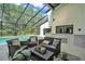 Covered patio with comfortable seating, an outdoor kitchen, and a view of the refreshing swimming pool at 4520 Pine Hollow Dr, Tampa, FL 33624