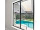 A view of the sparkling pool through a sliding glass door, emphasizing indoor-outdoor living at 4520 Pine Hollow Dr, Tampa, FL 33624