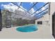 Aerial view of private pool area inside screened enclosure with ample deck space at 4520 Pine Hollow Dr, Tampa, FL 33624