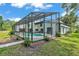 View of the screened-in pool and backyard, offering privacy and outdoor enjoyment at 4520 Pine Hollow Dr, Tampa, FL 33624