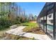 View of backyard and wooded area with screened-in pool at 4520 Pine Hollow Dr, Tampa, FL 33624