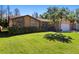 Charming single-Gathering home features a stone accent wall, mature landscaping, and a well-manicured lawn at 4908 Oakshire Dr, Tampa, FL 33625