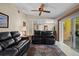 Spacious living room with plush sofas, ceiling fan, and sliding door to the exterior at 4908 Oakshire Dr, Tampa, FL 33625