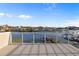 Spacious balcony with sleek railings offering panoramic views of the waterfront community and bright blue sky at 521 Baywood S Dr, Dunedin, FL 34698