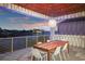 Covered outdoor dining area with water views featuring modern pendant lighting, table, and chairs at 521 Baywood S Dr, Dunedin, FL 34698