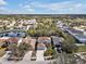 Neighborhood aerial view showcasing pond, tree coverage, and surrounding community at 5337 Treig Ln, Wesley Chapel, FL 33545