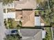 Aerial view showcasing roof, driveway, and lush landscaping at 5337 Treig Ln, Wesley Chapel, FL 33545