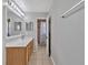 Bathroom with vanity, tile floor, and glass enclosed shower at 5337 Treig Ln, Wesley Chapel, FL 33545