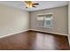 Bright bedroom featuring hardwood floors, neutral walls, and a large window with blinds at 5337 Treig Ln, Wesley Chapel, FL 33545