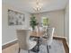 Elegant dining room with a chandelier, hardwood floors, and neutral colors at 5337 Treig Ln, Wesley Chapel, FL 33545