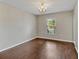 Empty dining room features hardwood floors, a chandelier, neutral paint, and a window at 5337 Treig Ln, Wesley Chapel, FL 33545