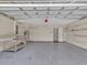 Spacious garage with work area and shelving for storage and projects at 5337 Treig Ln, Wesley Chapel, FL 33545