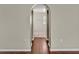 Hallway with wood floors and arched doorway to another room at 5337 Treig Ln, Wesley Chapel, FL 33545