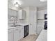 Kitchen features white cabinets, marble countertops, stainless-steel appliances, and a black dishwasher at 5337 Treig Ln, Wesley Chapel, FL 33545