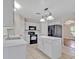 Bright kitchen with white cabinetry, modern appliances, and a functional island for meal preparation at 5337 Treig Ln, Wesley Chapel, FL 33545