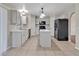 Kitchen features white cabinets, marble countertops, stainless-steel appliances, and a center island at 5337 Treig Ln, Wesley Chapel, FL 33545