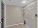 Well-lit laundry room with tile flooring and wire shelving at 5337 Treig Ln, Wesley Chapel, FL 33545