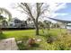 This waterfront backyard with grassy lawn provides direct access to the canal with boat dock and lift at 5440 Quist Dr, Port Richey, FL 34668