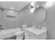 Modern bathroom with tiled walls, updated fixtures, and a tiled shower over tub combination at 5440 Quist Dr, Port Richey, FL 34668