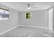 Light and bright empty bedroom with white marble floors, light grey paint, and a ceiling fan at 5440 Quist Dr, Port Richey, FL 34668